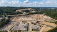 Aerial view of a large cleared construction site for a proposed data center development in Alabama.