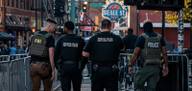 Law enforcement agents assigned to the Memphis Safe Task Force walk along Beale Street in downtown Memphis.
