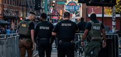 Law enforcement agents assigned to the Memphis Safe Task Force walk along Beale Street in downtown Memphis.