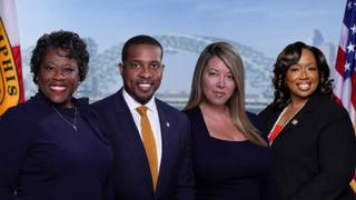 Councilwoman Yolanda Cooper-Sutton, Councilman JB Smiley Jr., Councilwoman Jerri Green, and Council Chairwoman Jana Swearengen-Washington stand together in front of a Memphis skyline backdrop.