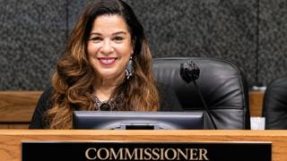 Commissioner Erika Sugarmon seated at the Shelby County Board of Commissioners dais behind her nameplate.