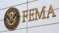 FEMA lettering and the U.S. Department of Homeland Security seal on a federal building facade.