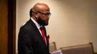 Former Shelby County corrections deputy Courtney Parham stands in a courtroom during his trial.