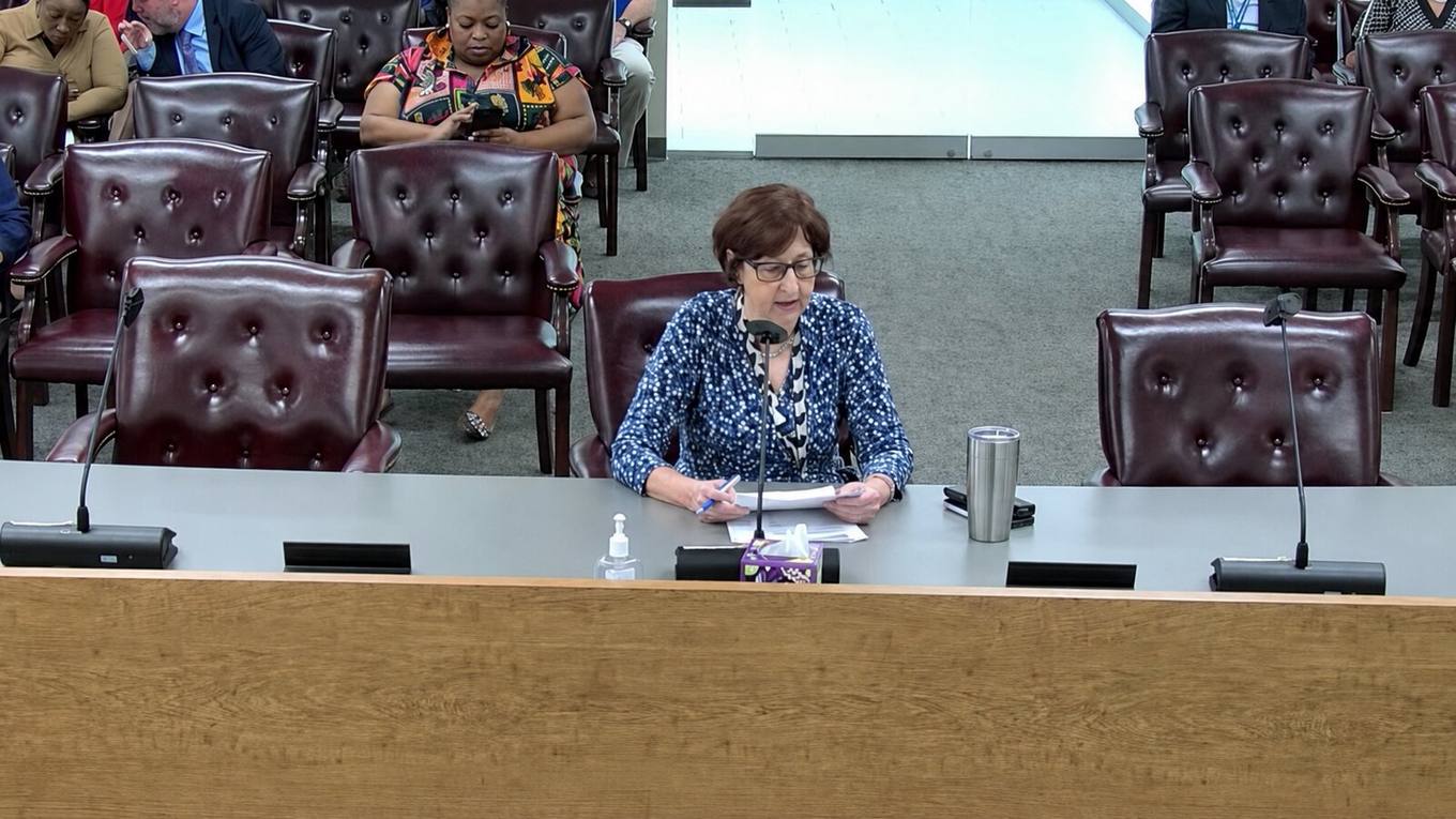 Danielle Schonbaum, Deputy Director of Administration and Finance for Shelby County, seated at the commission dais during a meeting.
