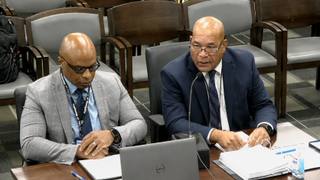 Two city officials seated at a witness table during a Memphis City Council committee meeting.