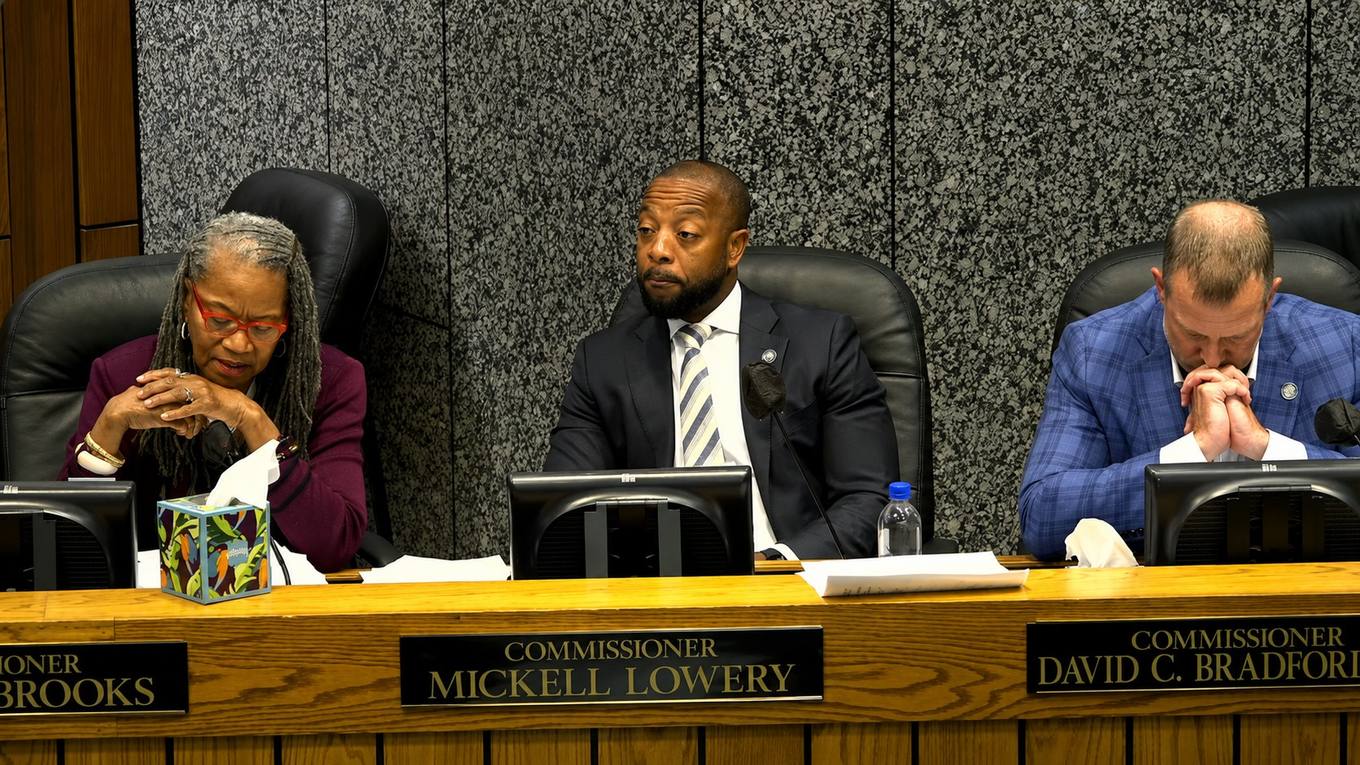 County commissioners seated at the dais during a commission meeting.