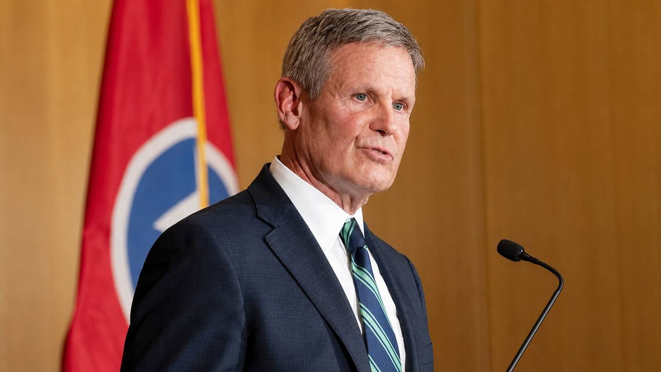 Tennessee Gov. Bill Lee at a podium with a Tennessee flag behind him.