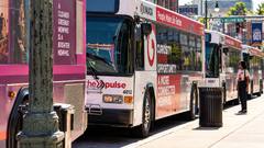 MATA transit buses lined up at a Memphis street bus stop in daylight.