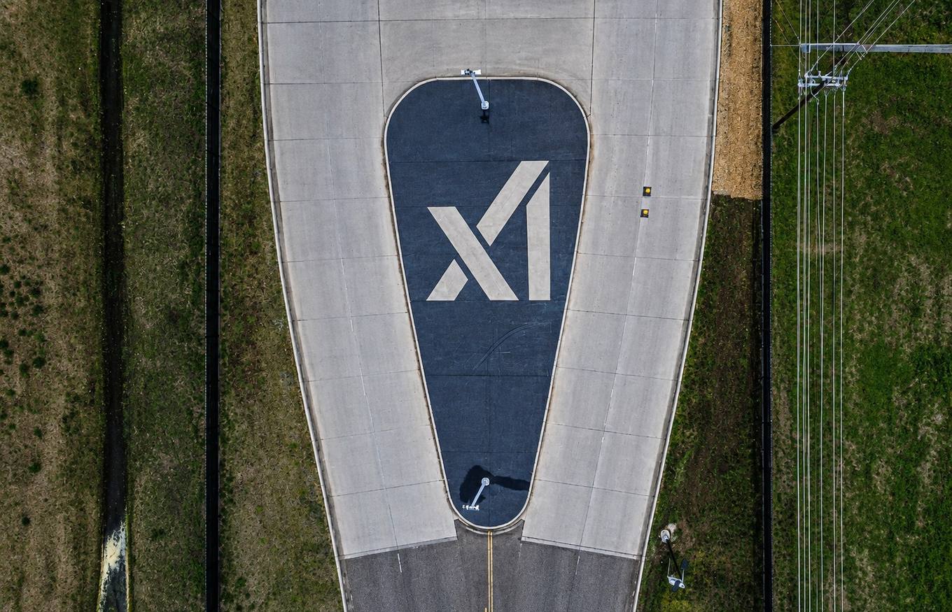 Aerial view of a paved access loop at the Memphis data center campus with the operator's logo painted on the roadway, near the properties named in the lien filings.
