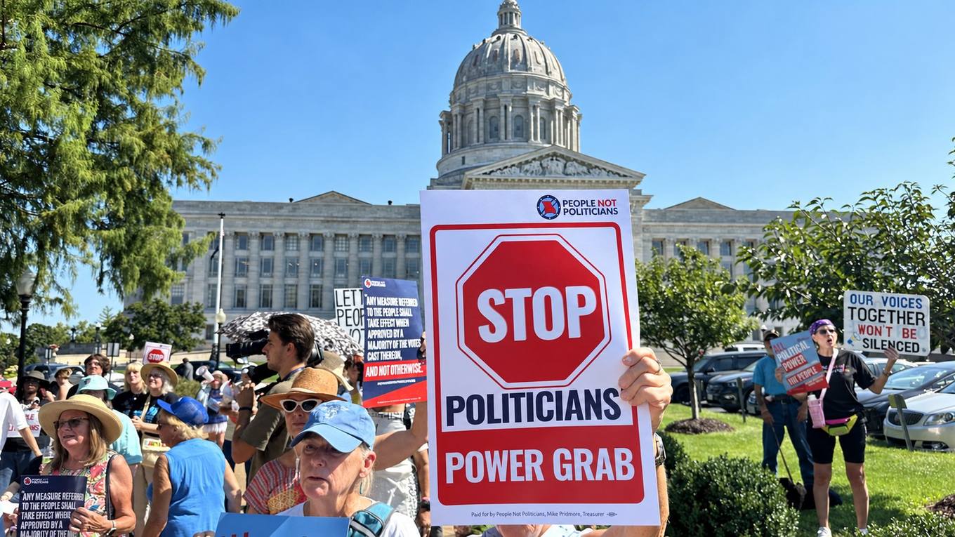 Protesters hold People Not Politicians signs outside the Missouri State Capitol in Jefferson City