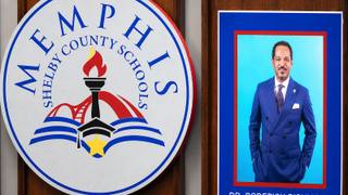 The Memphis-Shelby County Schools seal mounted on a wood wall beside a portrait of Superintendent Dr. Roderick Richmond.