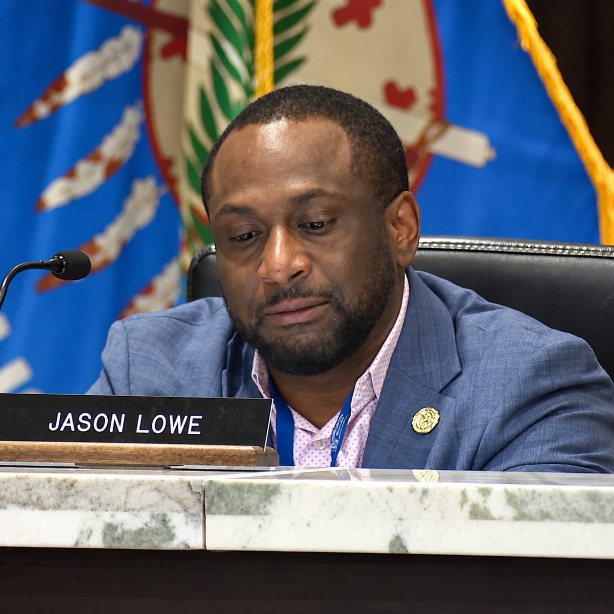 Oklahoma County Commissioner Jason Lowe seated at the dais during a Board of County Commissioners meeting.