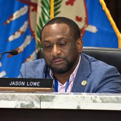 Oklahoma County Commissioner Jason Lowe seated at the dais during a Board of County Commissioners meeting.