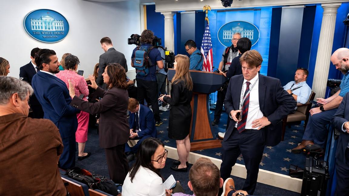 Journalists and camera crews gather in the James S. Brady Press Briefing Room at the White House in Washington, D.C.