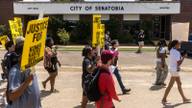 Protesters gather outside Senatobia City Hall in Senatobia, Mississippi, as controversy continues over the city's police chief.