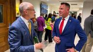State Sen. Brent Taylor speaks with Shelby County Sheriff's Office Chief Inspector Michael Green in a courthouse corridor.