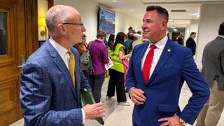 State Sen. Brent Taylor speaks with Shelby County Sheriff's Office Chief Inspector Michael Green in a courthouse corridor.