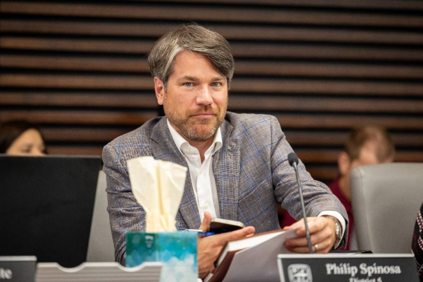 Councilman Philip Spinosa seated at the Memphis City Council dais with a microphone and papers in front of him during a council meeting.