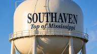 The "Top of Mississippi" water tower rising above Southaven, Mississippi against a clear blue sky.