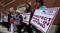 Supporters gather outside the federal courthouse in Boston on June 2, 2026, following a hearing in a lawsuit brought by a coalition of Democratic state attorneys general challenging President Donald Trump's executive order tightening rules on mail-in voting.