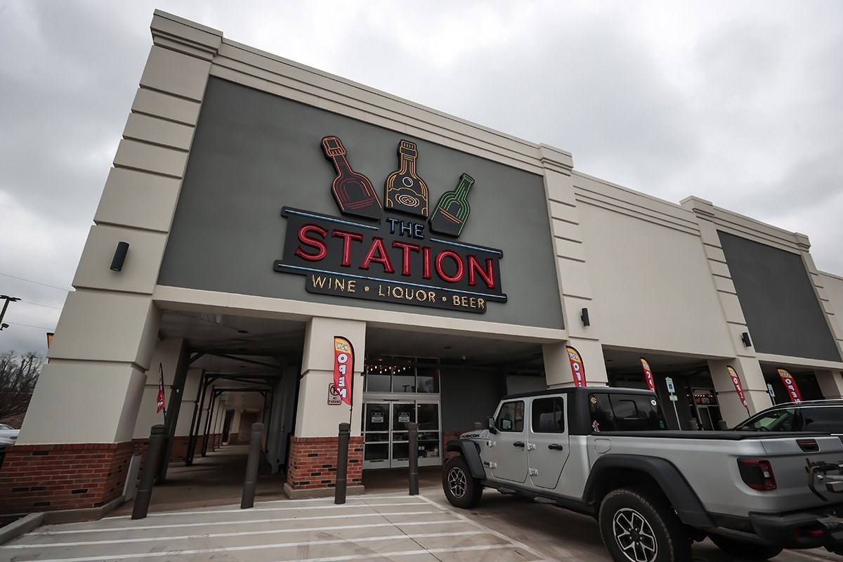 A large suburban retail storefront in a strip shopping center with a wide parking lot.